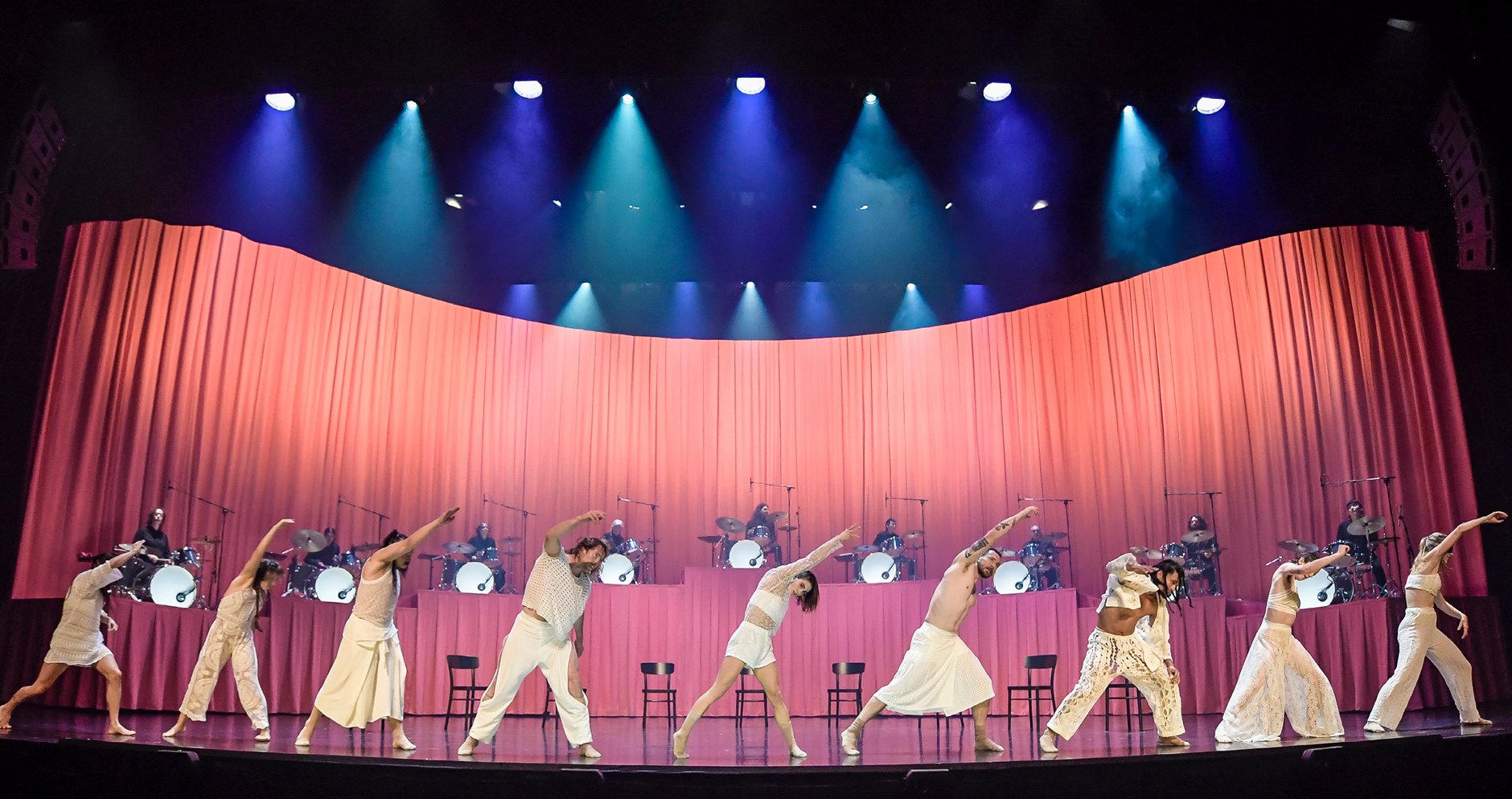 Manifesto at Adelaide Festival 2022. Nine dancers on stage wearing all white outfits